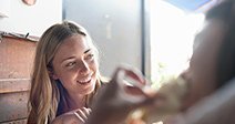 Young women sitting at cafe, eating lunch - Stock Photo